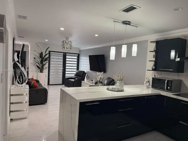 a kitchen with a sink appliances and cabinets