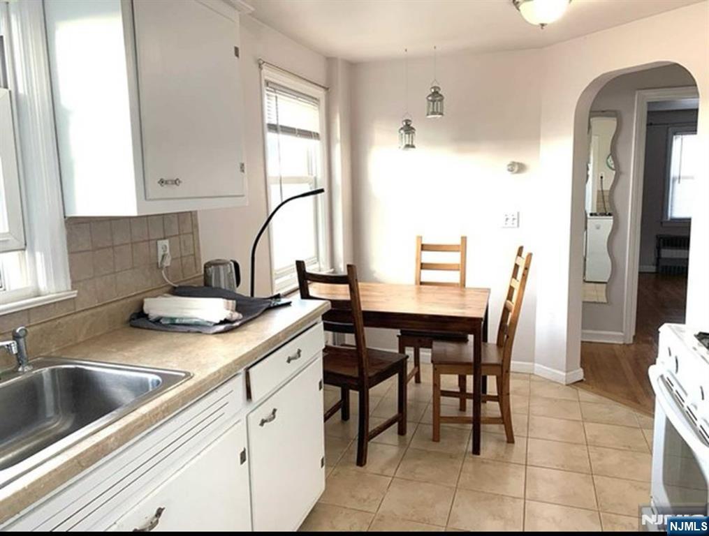 321 Roff Avenue Palisades Park, NJ 07650 - Photo 11 of 12 a kitchen with a white cabinets and chairs