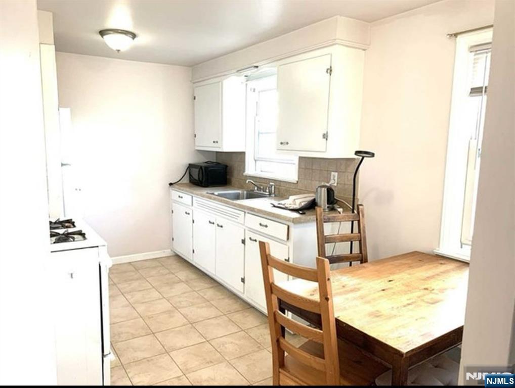 321 Roff Avenue Palisades Park, NJ 07650 - Photo 12 of 12 a kitchen with a stove a sink and a refrigerator