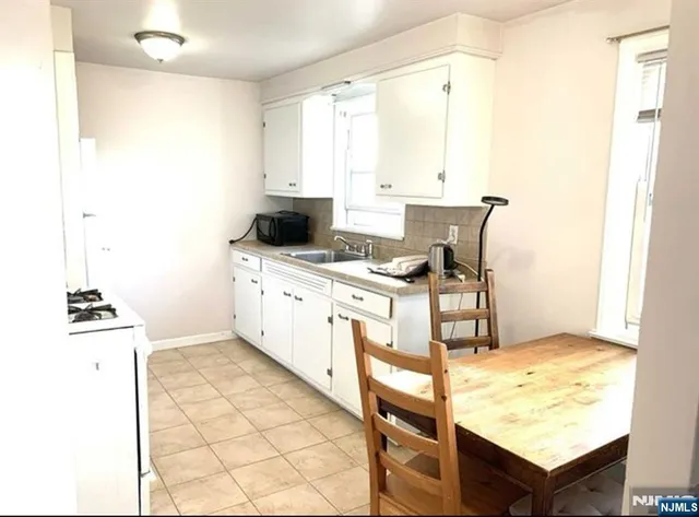 a kitchen with a stove a sink and a refrigerator