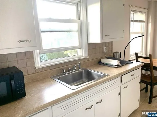 a kitchen with granite countertop a sink and a window