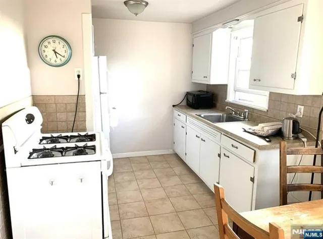 a kitchen with a stove and a white cabinet