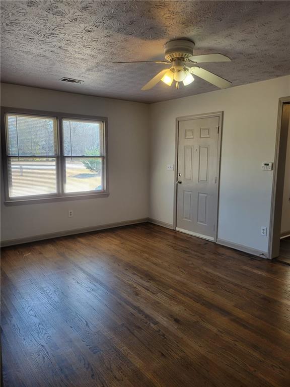 1063 Pleasant Hill Road, Unit A Lawrenceville, GA 30044 - Photo 11 of 18 an empty room with wooden floor and windows