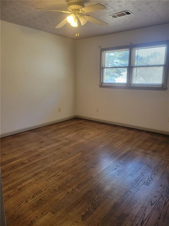 1063 Pleasant Hill Road, Unit A Lawrenceville, GA 30044 - Photo 12 of 18 an empty room with wooden floor and windows