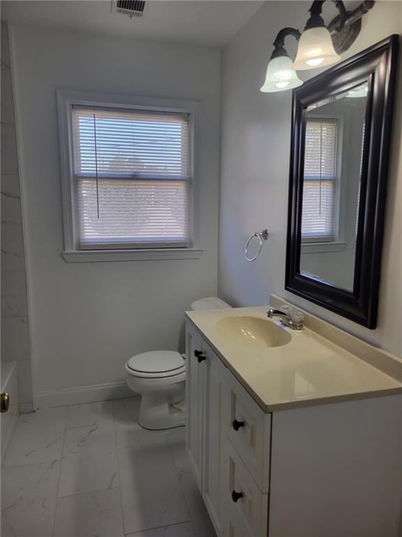 1063 Pleasant Hill Road, Unit A Lawrenceville, GA 30044 - Photo 14 of 18 a bathroom with a granite countertop sink toilet and mirror