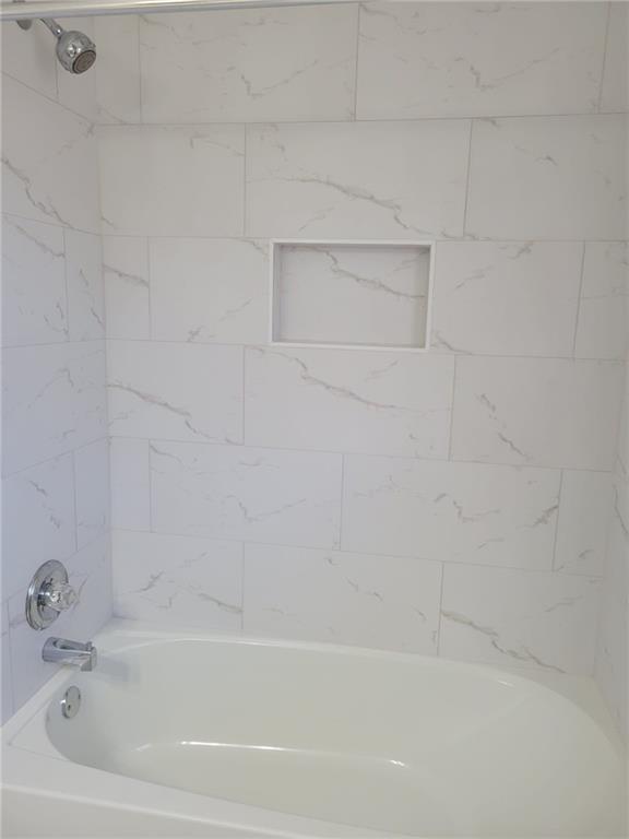 1063 Pleasant Hill Road, Unit A Lawrenceville, GA 30044 - Photo 16 of 18 a bathroom with a bathtub
