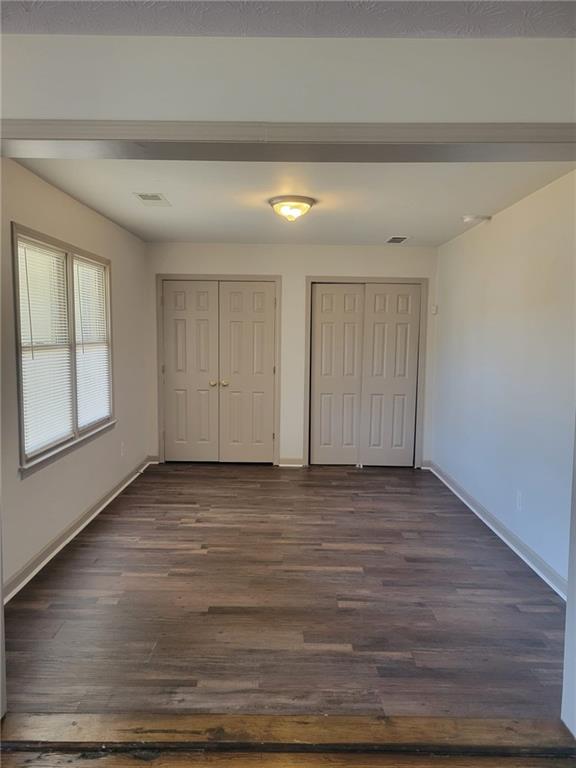 1063 Pleasant Hill Road, Unit A Lawrenceville, GA 30044 - Photo 6 of 18 a view of an empty room with window and wooden floor