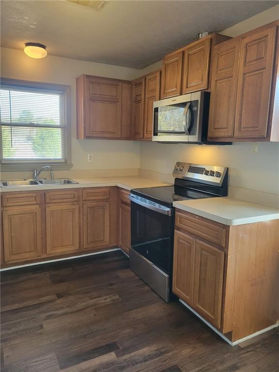 1063 Pleasant Hill Road, Unit A Lawrenceville, GA 30044 - Photo 8 of 18 a kitchen with stainless steel appliances a stove a sink and cabinets