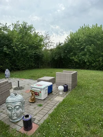 a backyard of a house with table and chairs