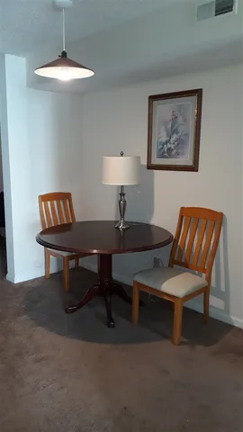 a living room with furniture and a lamp