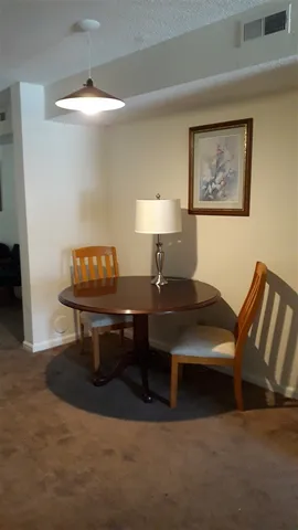 a living room with furniture a lamp and a window