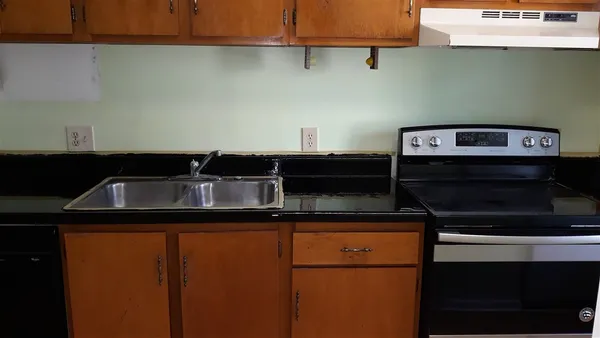 a close view of a sink and cabinets