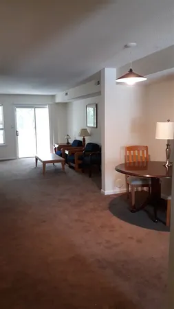 a living room with furniture and a piano