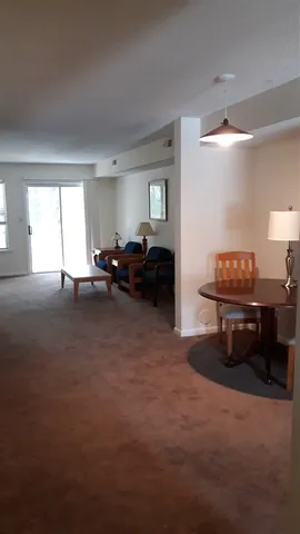 a living room with furniture and a piano