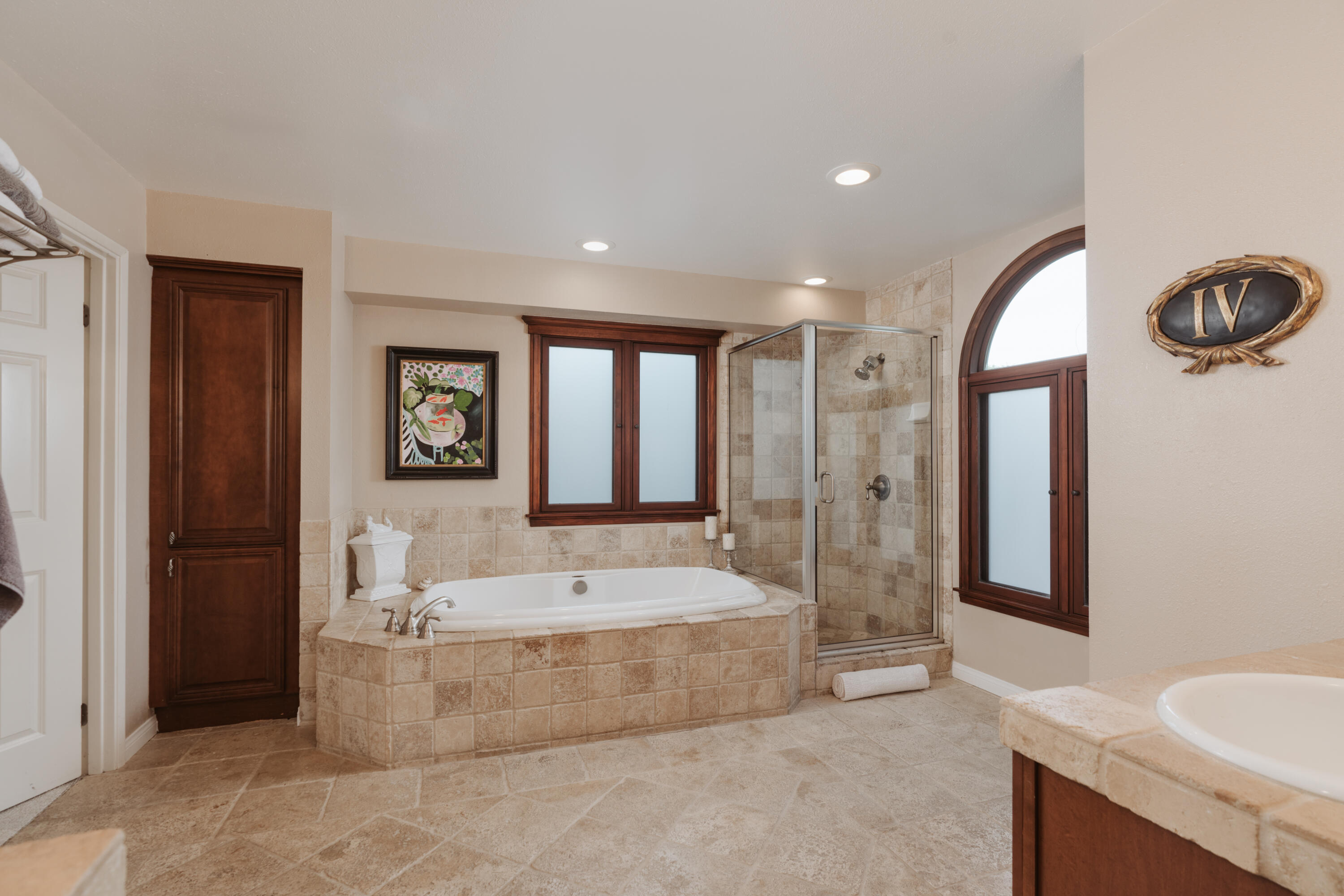 844 Meigs Road Santa Barbara, CA 93109 - Photo 15 of 32 a spacious bathroom with a tub a double vanity sink and a large mirror