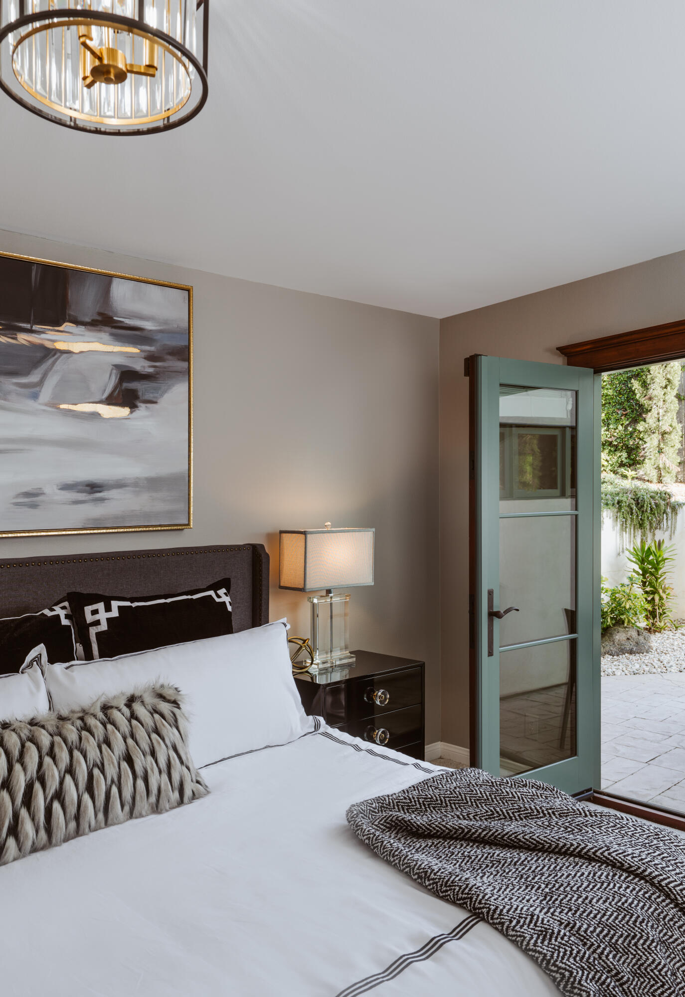844 Meigs Road Santa Barbara, CA 93109 - Photo 18 of 32 a bedroom with a bed and a chandelier