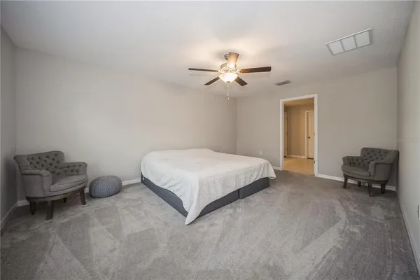 a bedroom with a bed and a chair