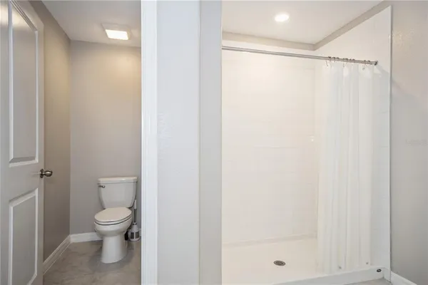 a bathroom with a shower a toilet and a shower