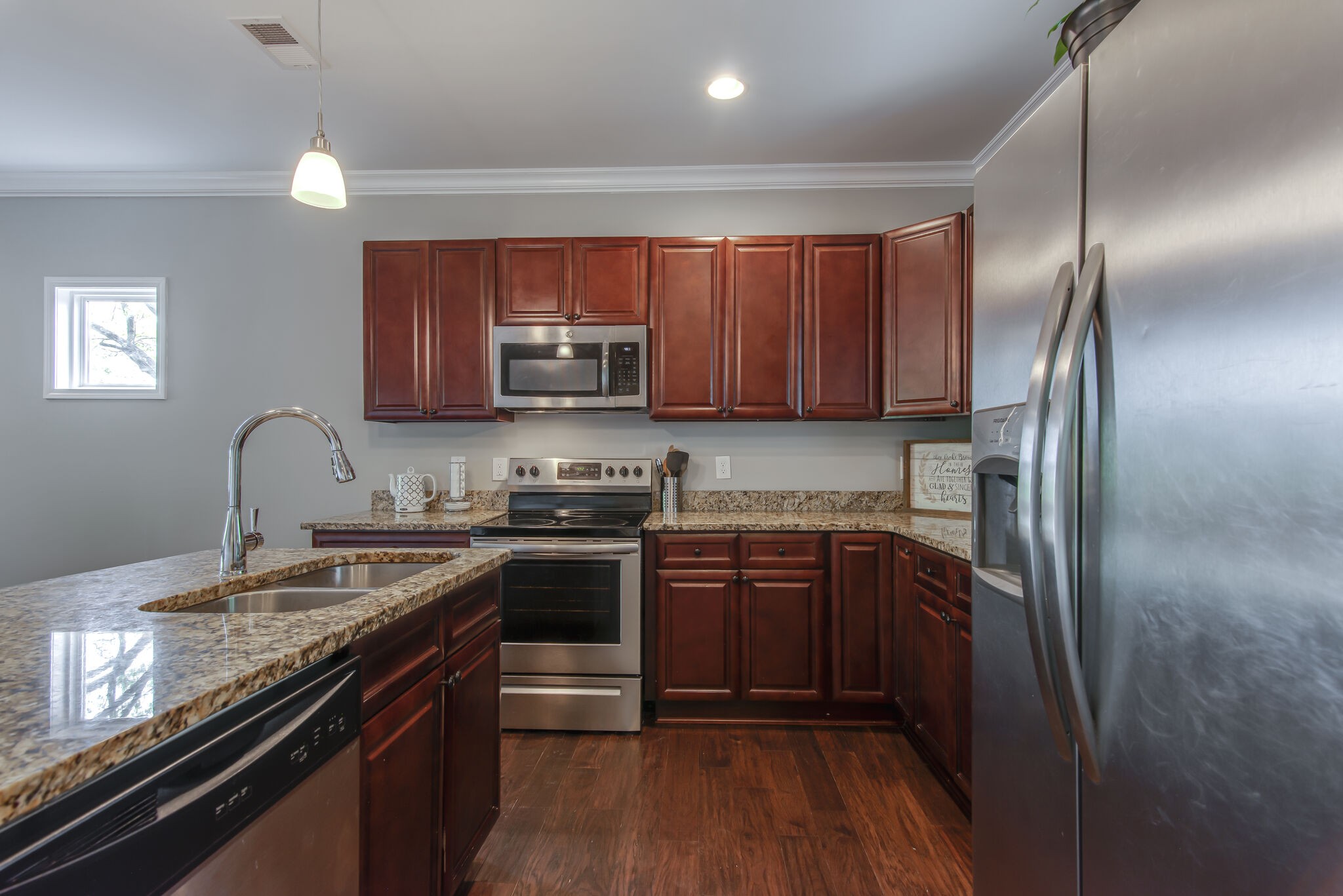 357 Flora Maxwell Road Nashville, TN 37211 - Photo 12 of 31 a kitchen with stainless steel appliances granite countertop a stove top oven a sink dishwasher a refrigerator and cabinets with wooden floor