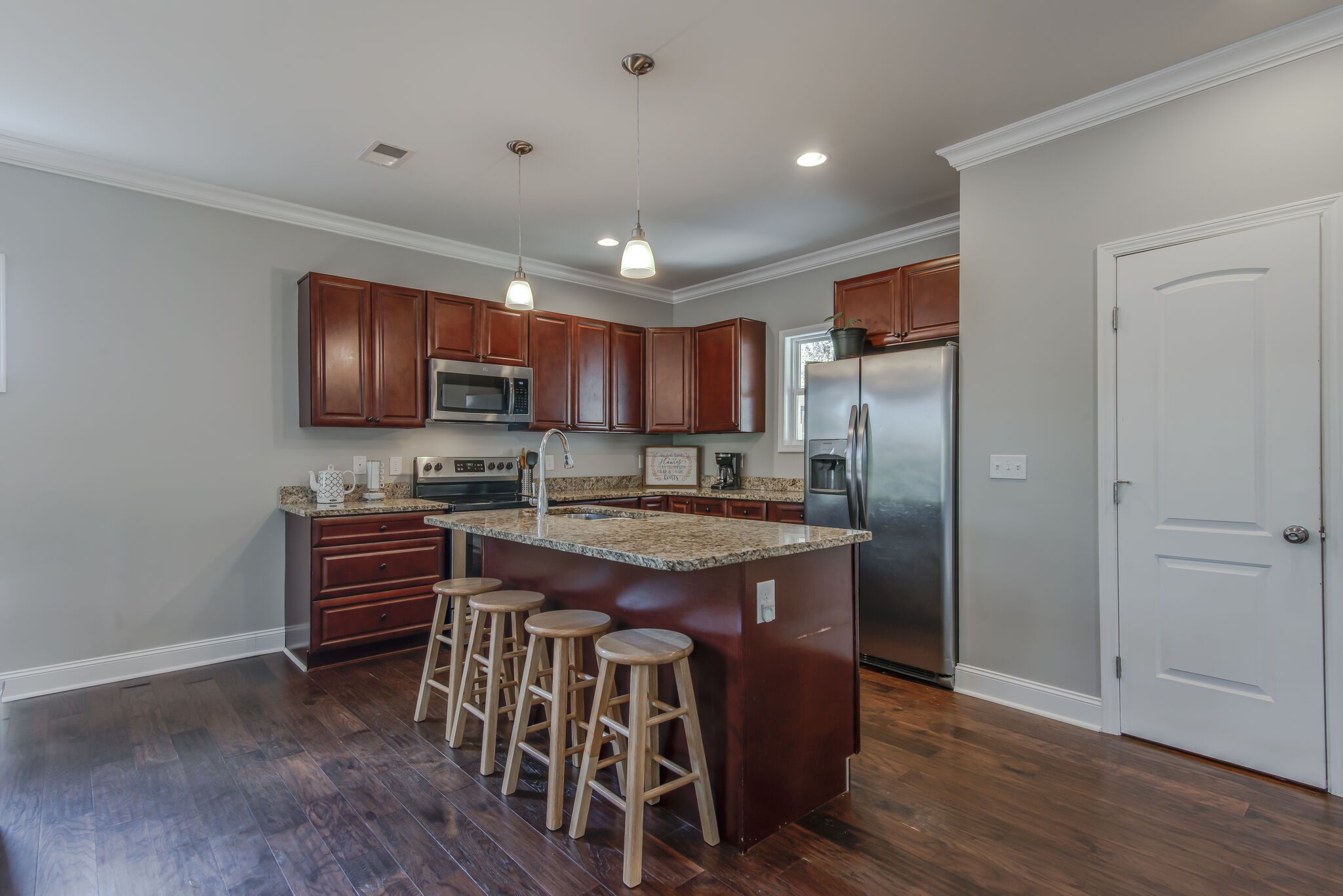357 Flora Maxwell Road Nashville, TN 37211 - Photo 10 of 31 a kitchen with stainless steel appliances granite countertop a table chairs sink and cabinets