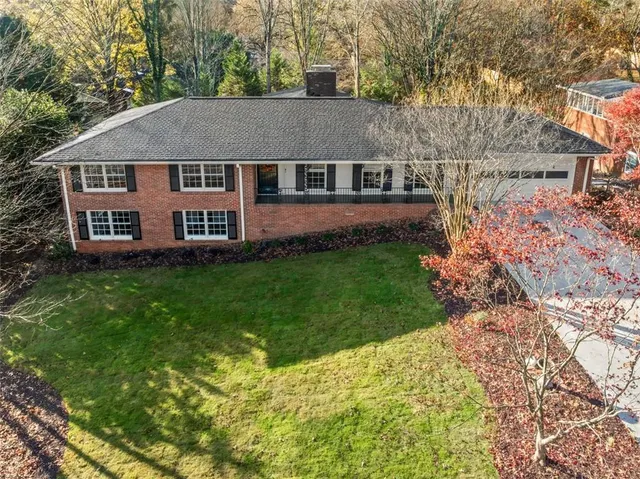 a aerial view of a house with a yard table and chairs