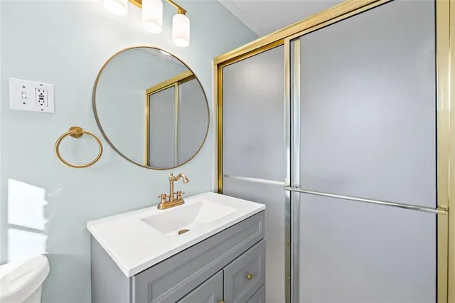 an empty room with wooden floor and ceiling fan