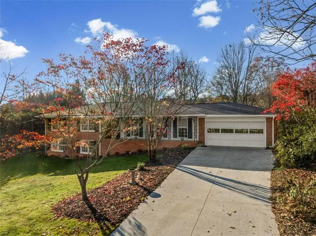 a front view of a house with a yard and a garage