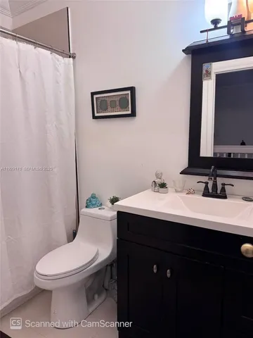a bathroom with a toilet a sink and a mirror