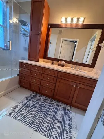 a view of a closet with wooden floor