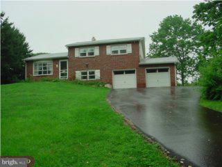 1565 Clemens Road Harleysville, PA 19438 - Photo 1 of 1 a front view of a house with a garden
