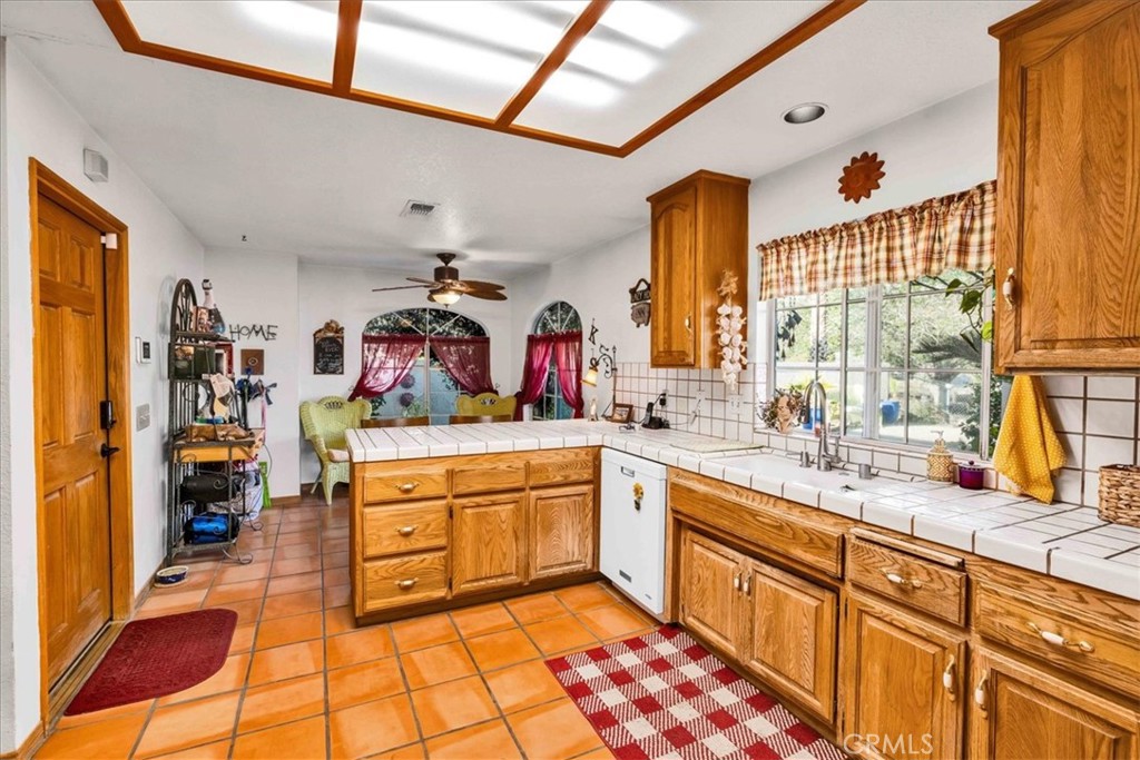 10341 Pinon Avenue Morongo Valley, CA 92256 - Photo 14 of 68 a large kitchen with stainless steel appliances granite countertop a sink and cabinets
