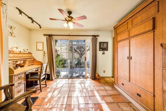 a bedroom with a bed mirror and window