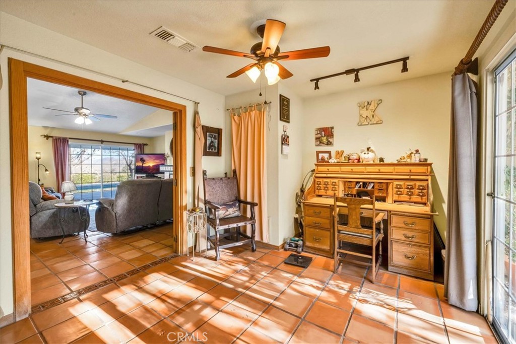 10341 Pinon Avenue Morongo Valley, CA 92256 - Photo 17 of 68 a living room with granite countertop furniture and a chandelier