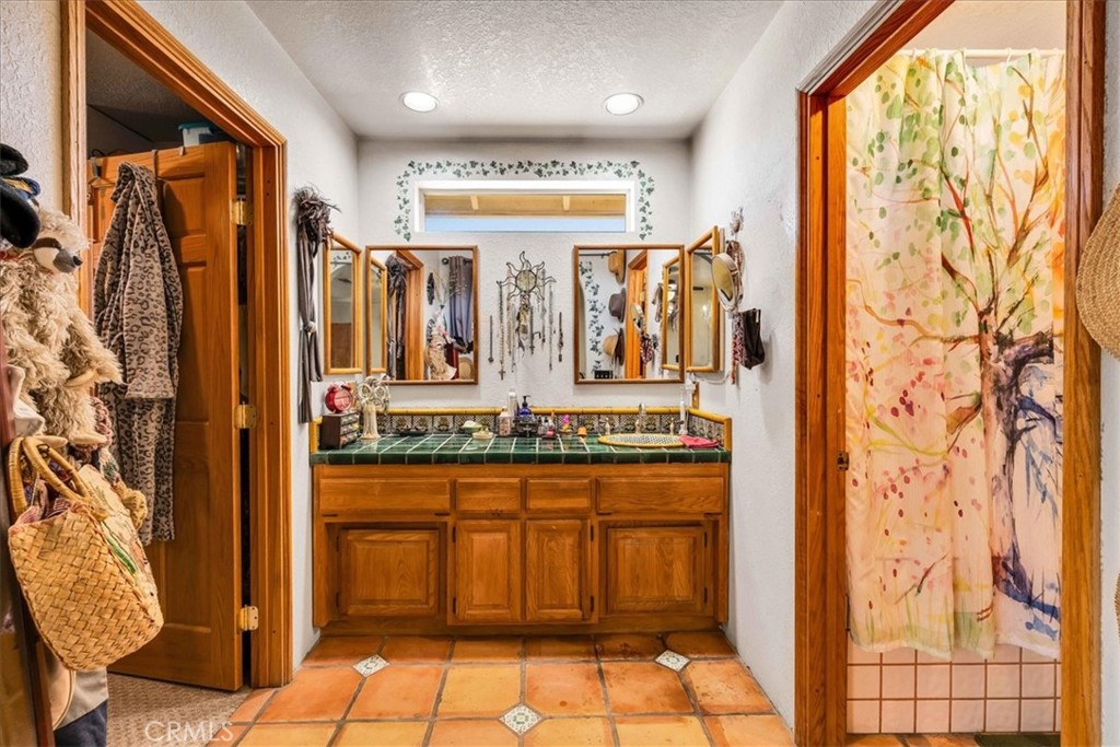 10341 Pinon Avenue Morongo Valley, CA 92256 - Photo 23 of 68 a bathroom with a granite countertop sink and a mirror
