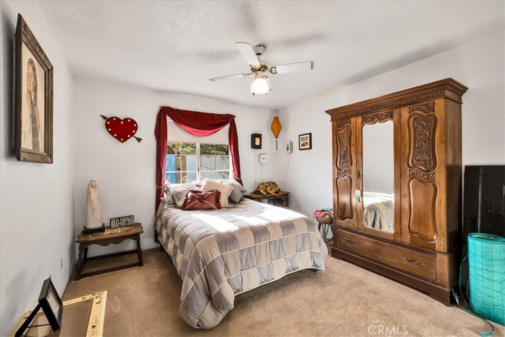 10341 Pinon Avenue Morongo Valley, CA 92256 - Photo 25 of 68 a bedroom with a bed and a chandelier