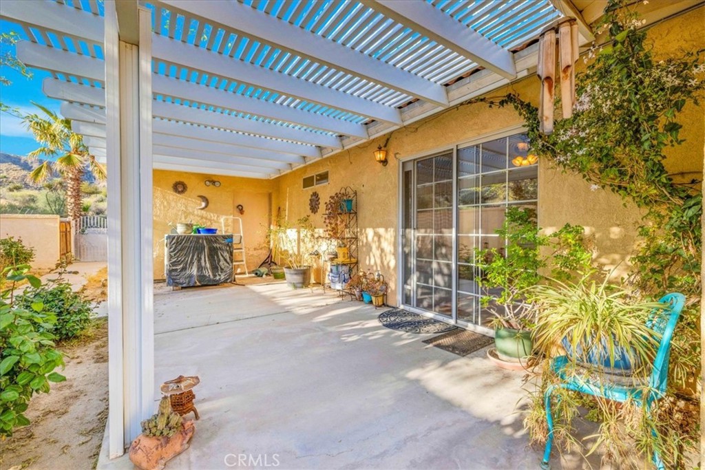 10341 Pinon Avenue Morongo Valley, CA 92256 - Photo 30 of 68 a view of a patio with table and chairs and potted plants