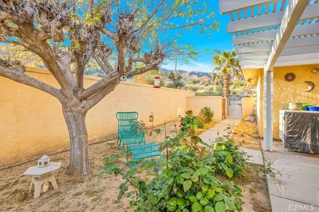 a view of a house with a dining table and chairs