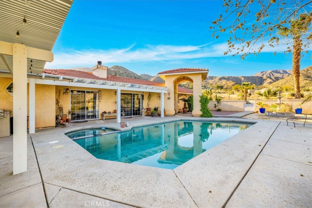 10341 Pinon Avenue Morongo Valley, CA 92256 - Photo 37 of 68 a view of a house with a swimming pool