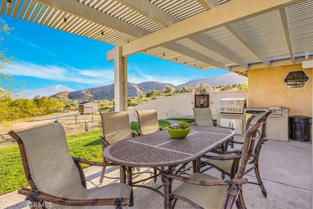 10341 Pinon Avenue Morongo Valley, CA 92256 - Photo 38 of 68 a view of an outdoor dining space with a table and chairs
