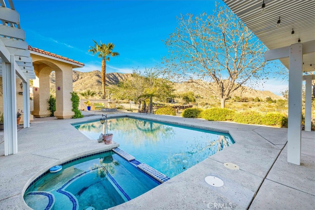 10341 Pinon Avenue Morongo Valley, CA 92256 - Photo 39 of 68 a view of a swimming pool with a patio