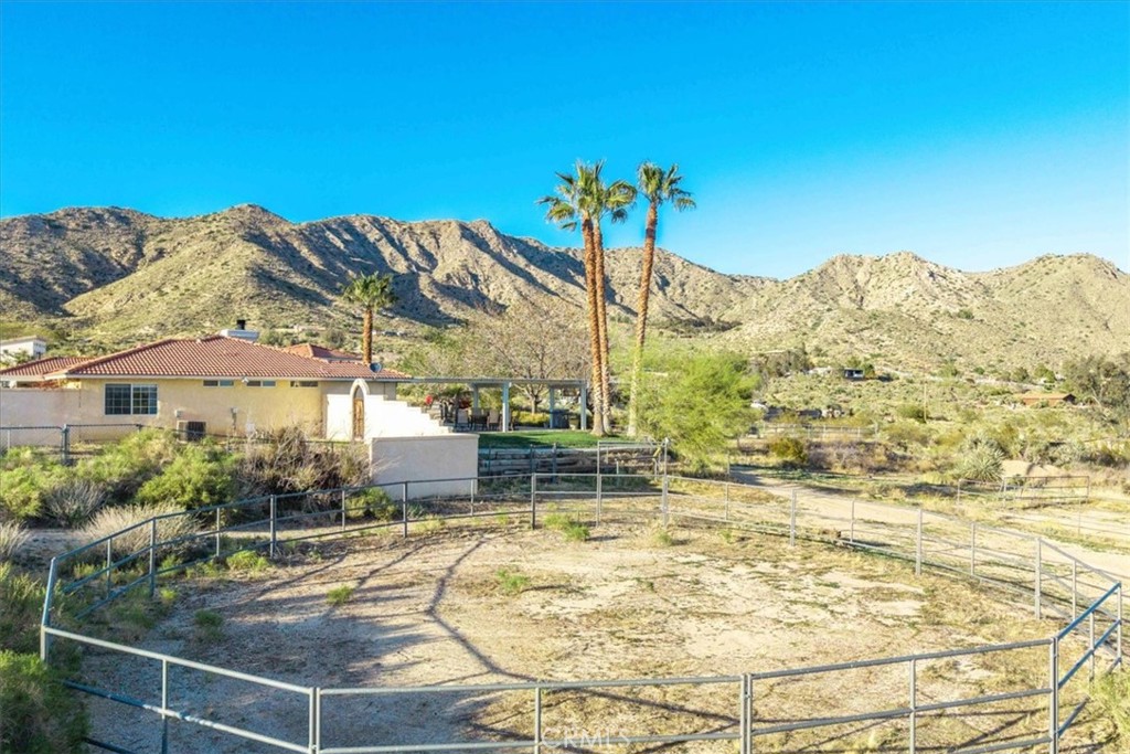 10341 Pinon Avenue Morongo Valley, CA 92256 - Photo 43 of 68 a view of a swimming pool with a table and chairs