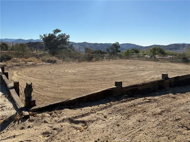 a view of a dry yard with mountains