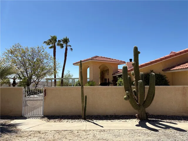 a living room with furniture a fireplace and a large window