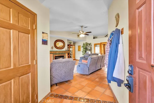a view of a hallway with wooden floor and chandelier