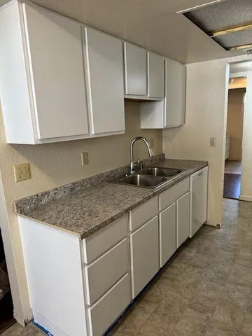 a kitchen with stainless steel appliances granite countertop a sink stove and cabinets