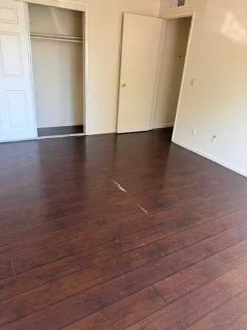 an empty room with wooden floor