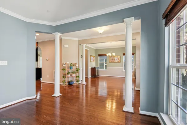 a view of living room with kitchen island stainless steel appliances wooden floor and living room view