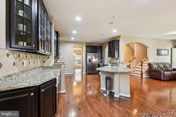 a kitchen with stainless steel appliances granite countertop wooden cabinets and a granite counter tops