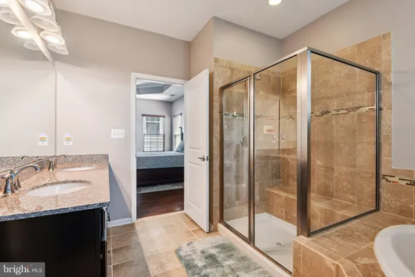 a bathroom with a sink vanity mirror and toilet