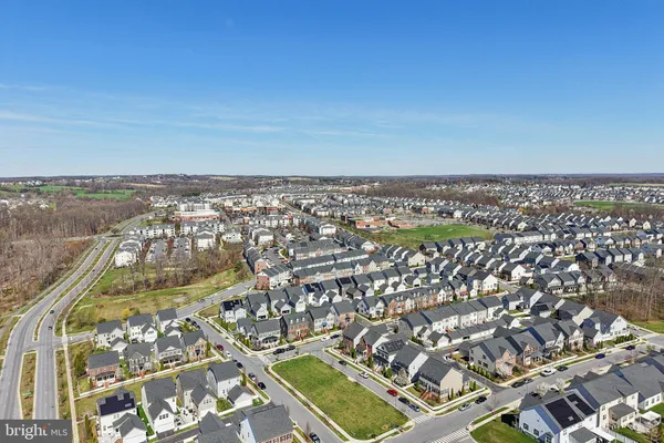 an aerial view of residential building with yard